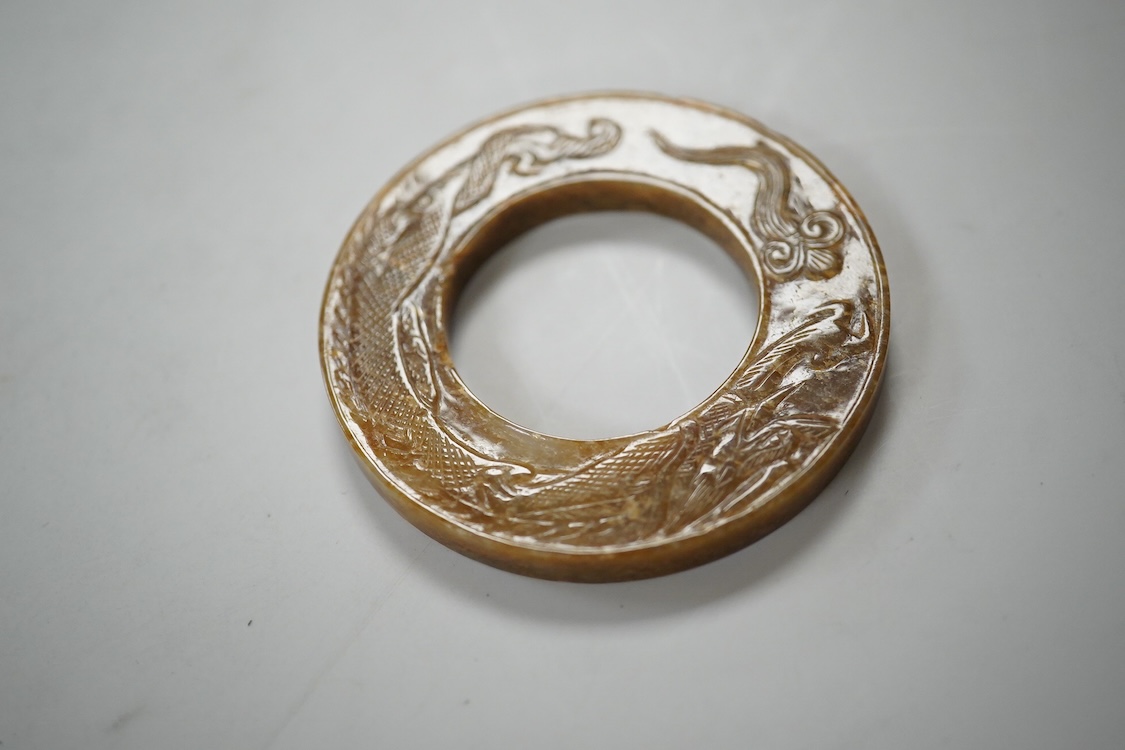 A Chinese russet jade dragon disc, 5.5cm diameter